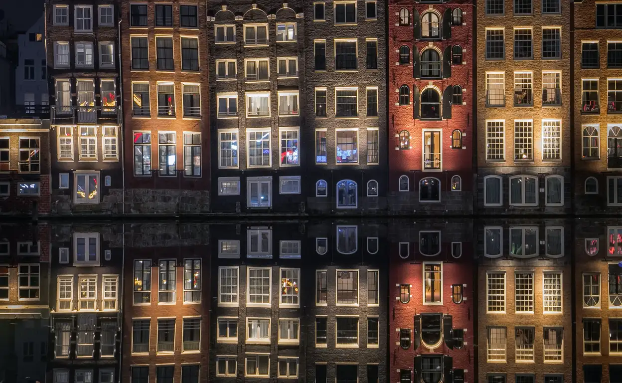 Grachtenpanden in Amsterdam in de avond met lichten