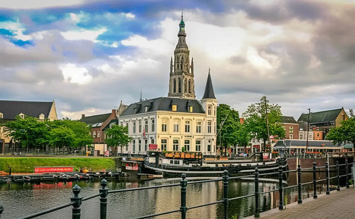 Een rivier met een brug en een kerk in Breda op de achtergrond. Prachtig landschap met historische architectuur.