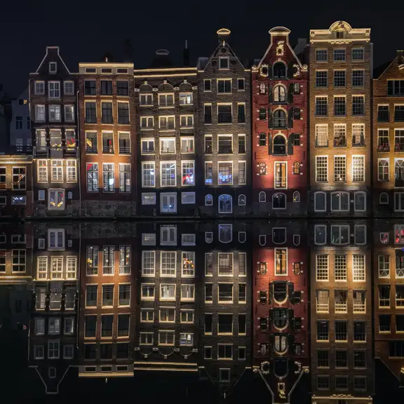 Grachtenpanden in Amsterdam in de avond met lichten